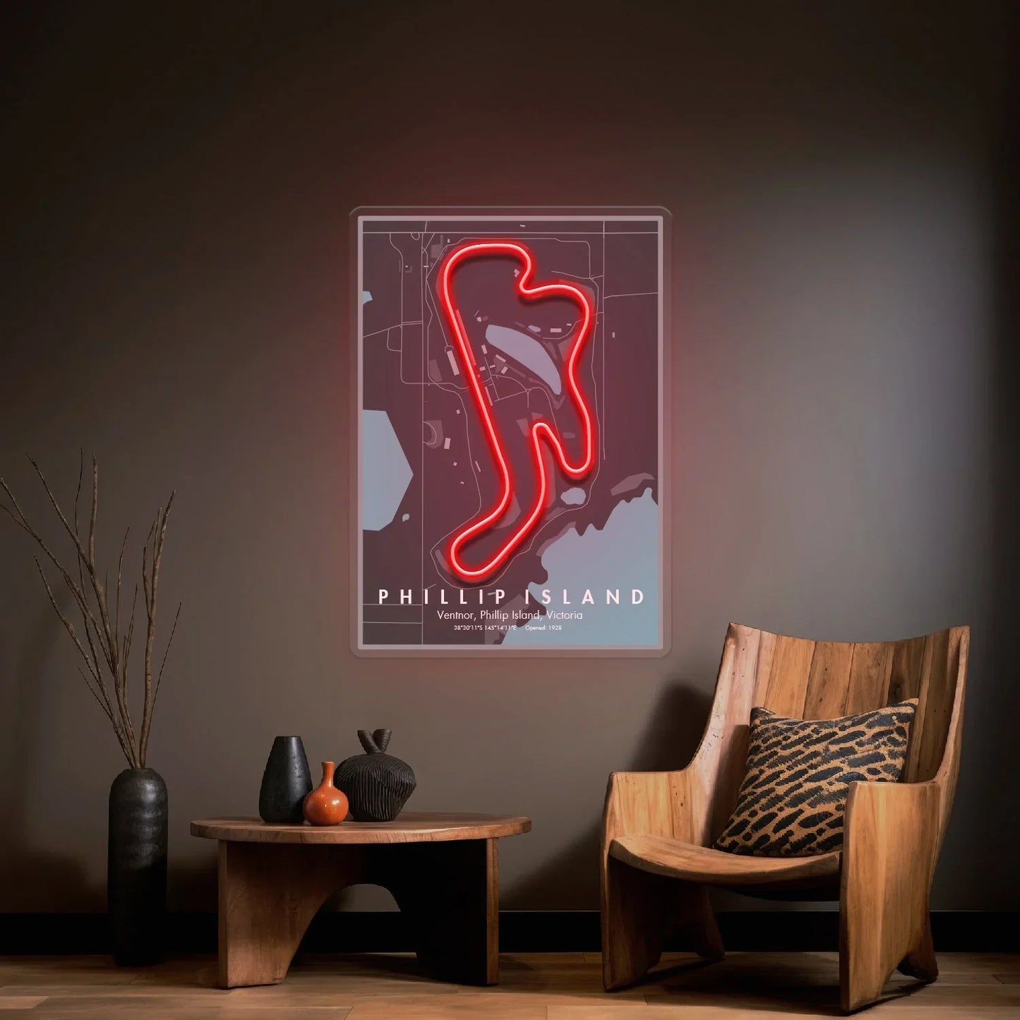 Modern living room with wooden chair, table, decorative vases, and neon-lit Phillip Island F1 circuit wall art