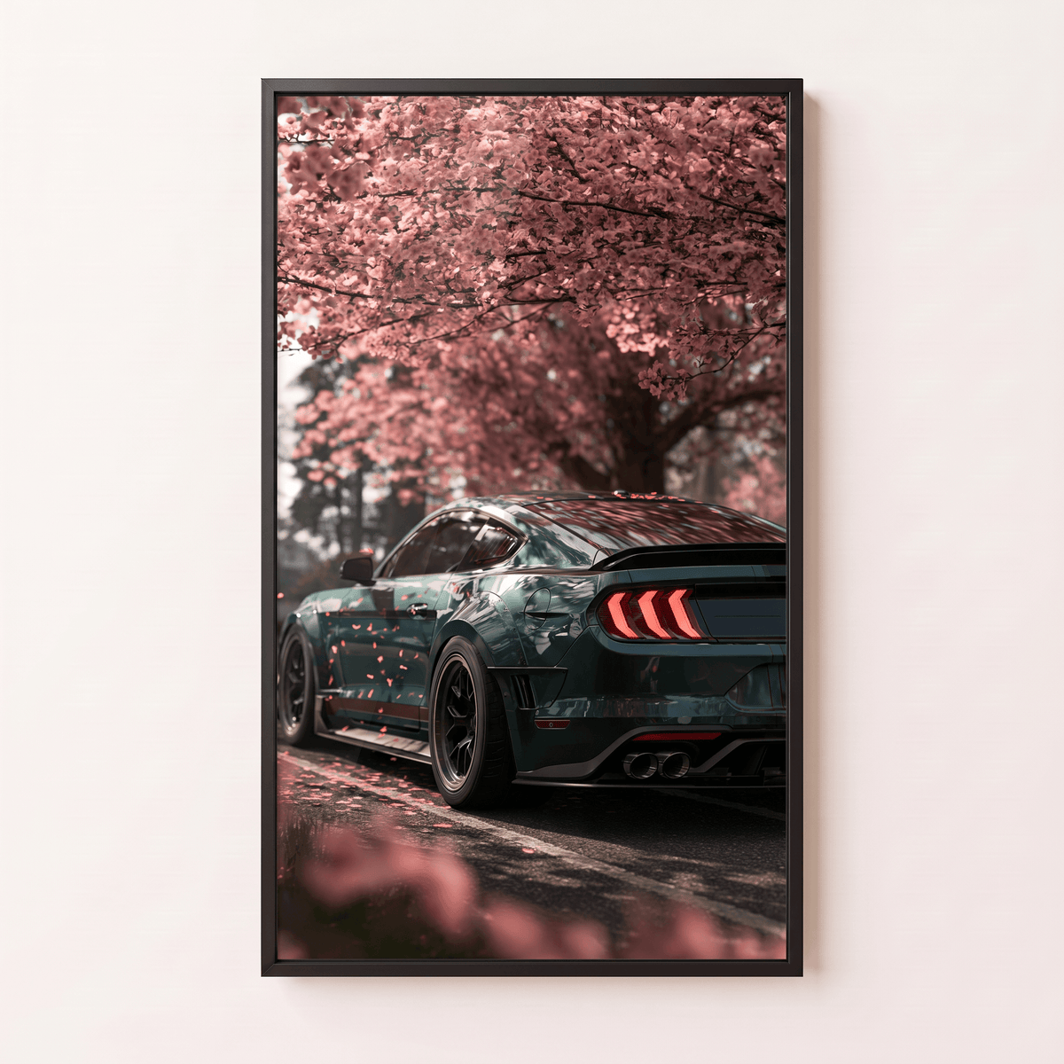 Framed canvas wall art featuring a dark muscle car parked under blooming pink cherry blossom trees in a modern black frame.