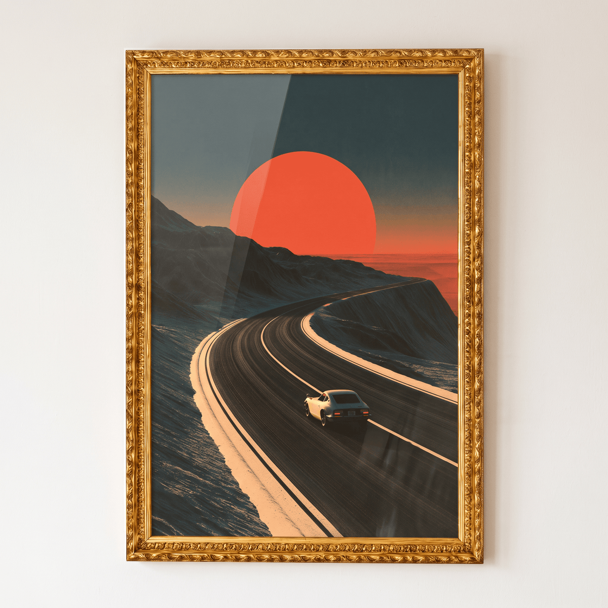Framed canvas wall art in an ornate gold frame featuring a vintage sports car driving down a mountain highway at sunset beneath a giant glowing red sun.