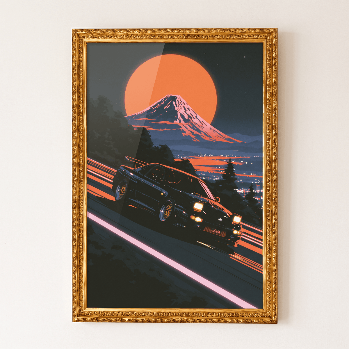 JDM sports car drifting down mountain pass with Mount Fuji and full moon art print in an ornate gold frame on a neutral wall.