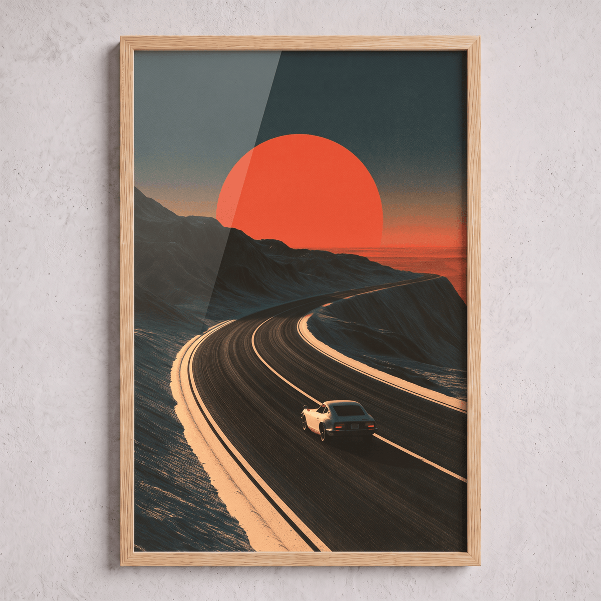 Oak framed canvas print of a classic vintage sports car driving along a winding coastal highway towards a massive red sunset.