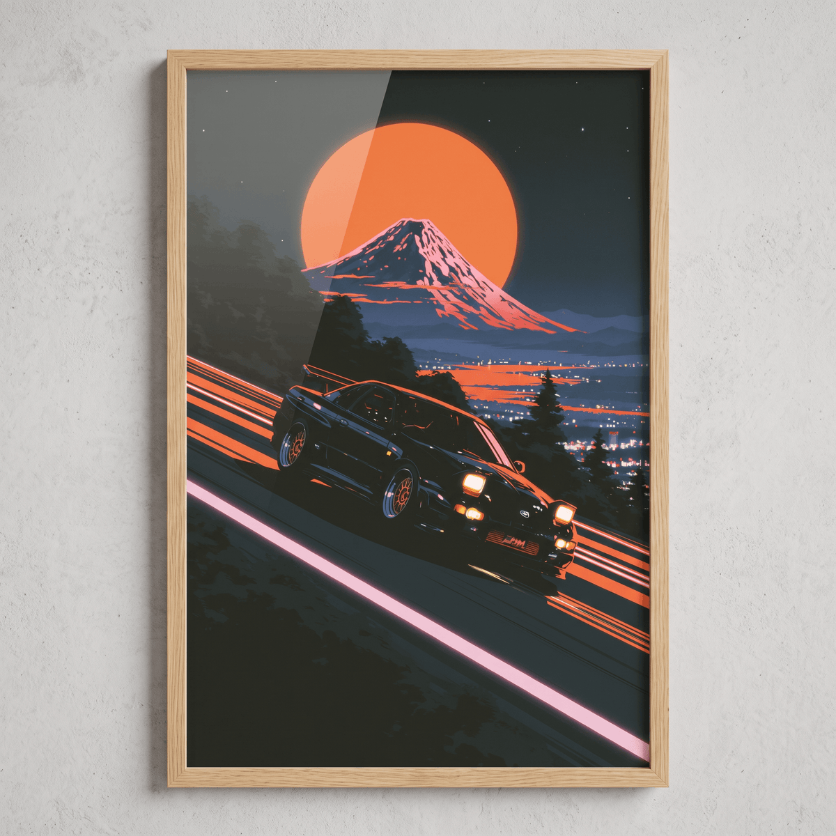 Framed canvas wall art in a natural oak frame featuring a Japanese sports car drifting down a mountain pass with Mount Fuji and sunset moon.