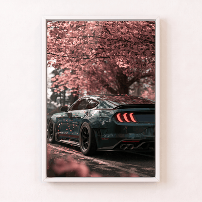 Modern muscle sports car beneath falling cherry blossoms framed canvas wall art in a clean white frame.