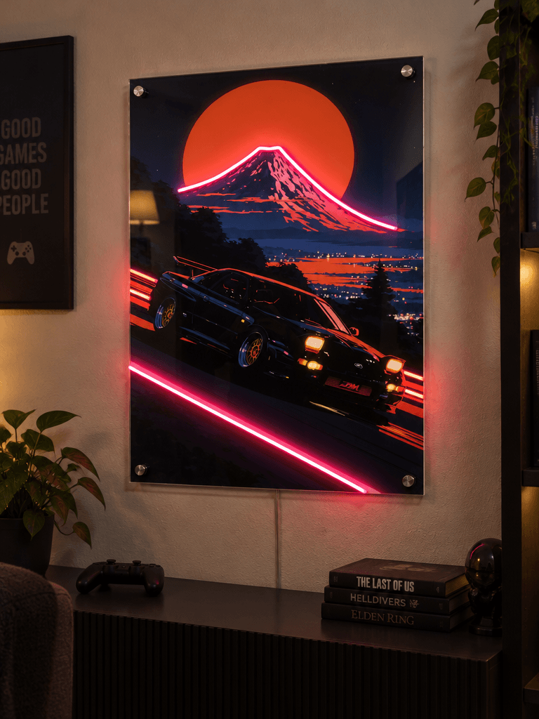 Glowing LED neon acrylic wall art featuring a retro sports car drifting near Mount Fuji, displayed above a media console in a stylish gaming room setup.