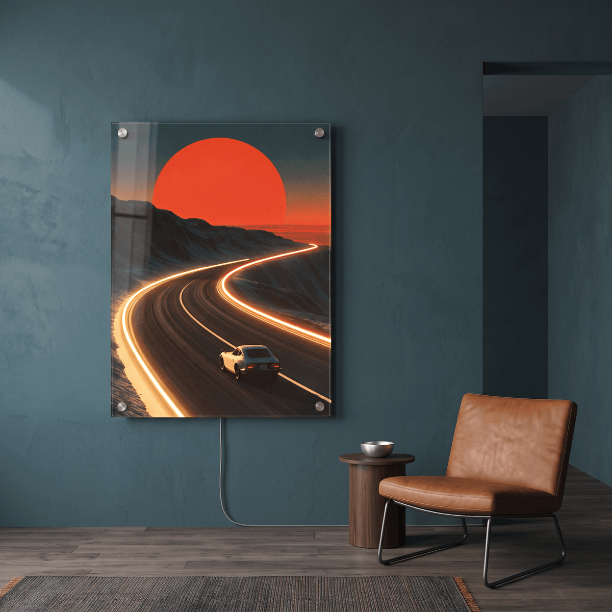 Glowing LED neon acrylic wall art of a vintage sports car driving towards a setting sun on a winding highway, mounted in a modern living room.