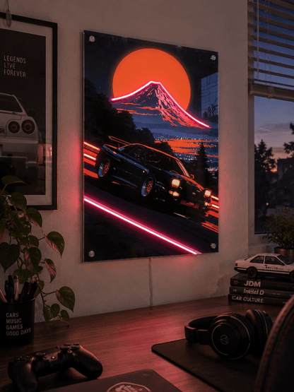 Glowing LED neon acrylic wall art of a JDM sports car drifting near Mount Fuji with synthwave neon accents in a modern gaming room desk setup.