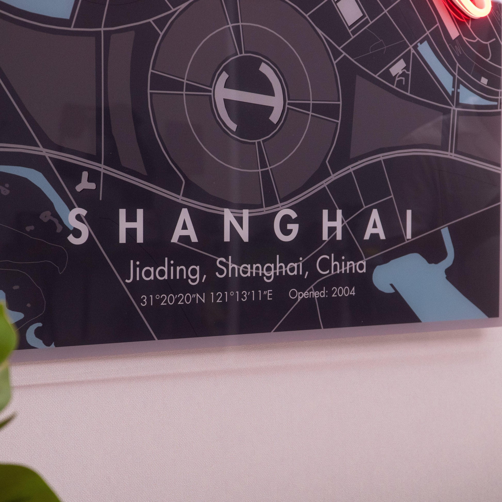 Close-up of a stylized map poster of Jiading, Shanghai, China with coordinates and opening year 2004 on wall
