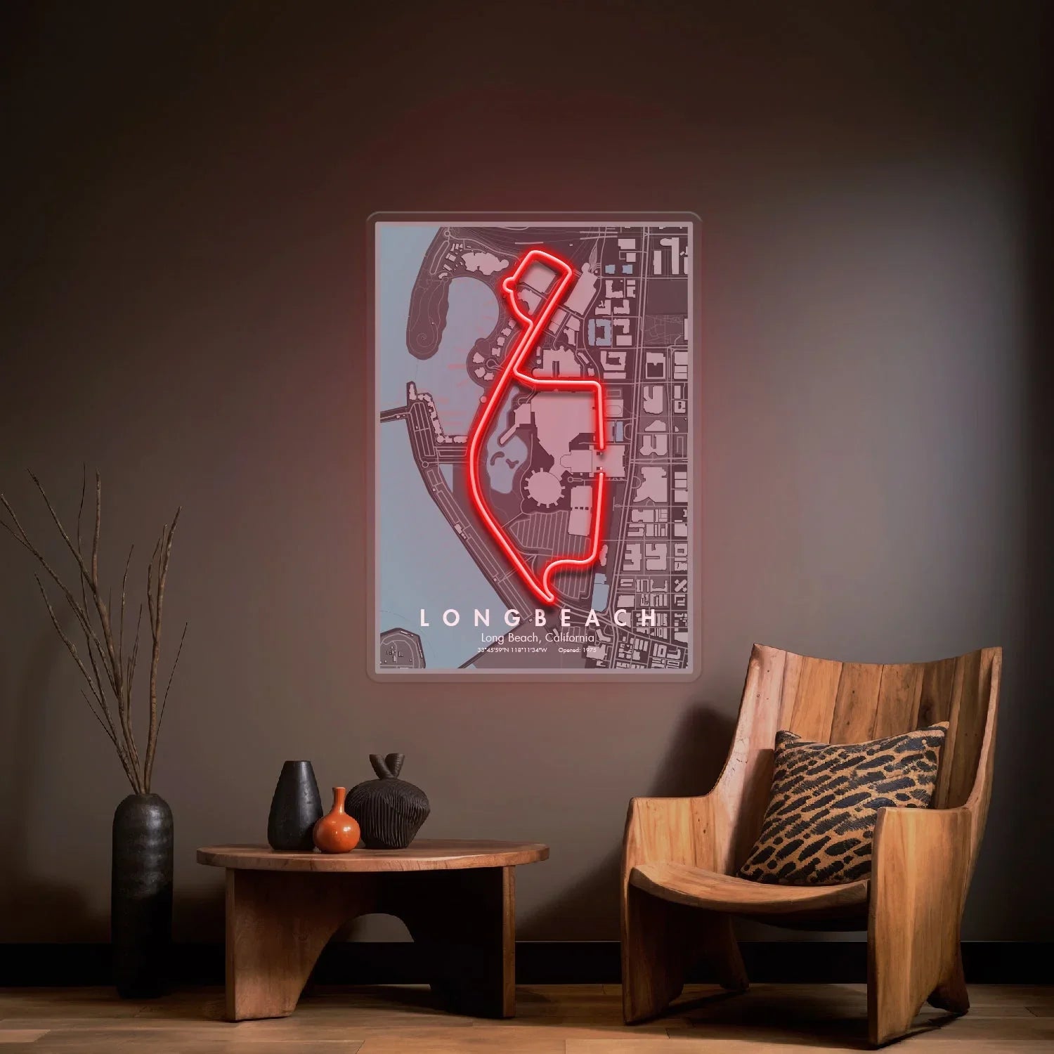 Long Beach Formula 1 circuit map with neon red track outline on wall over wooden chair and table