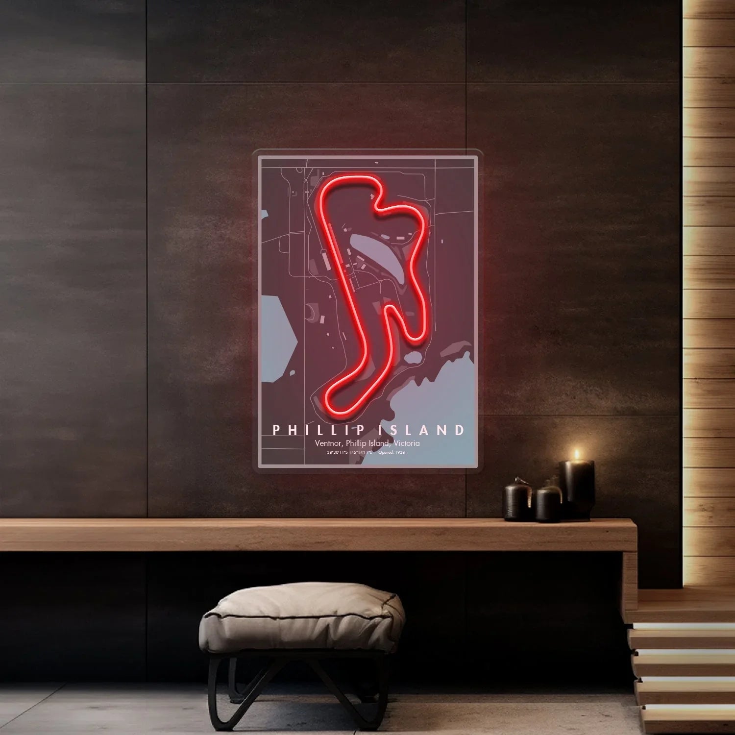 Neon red Phillip Island race circuit map art on dark wall in modern room with bench and candles