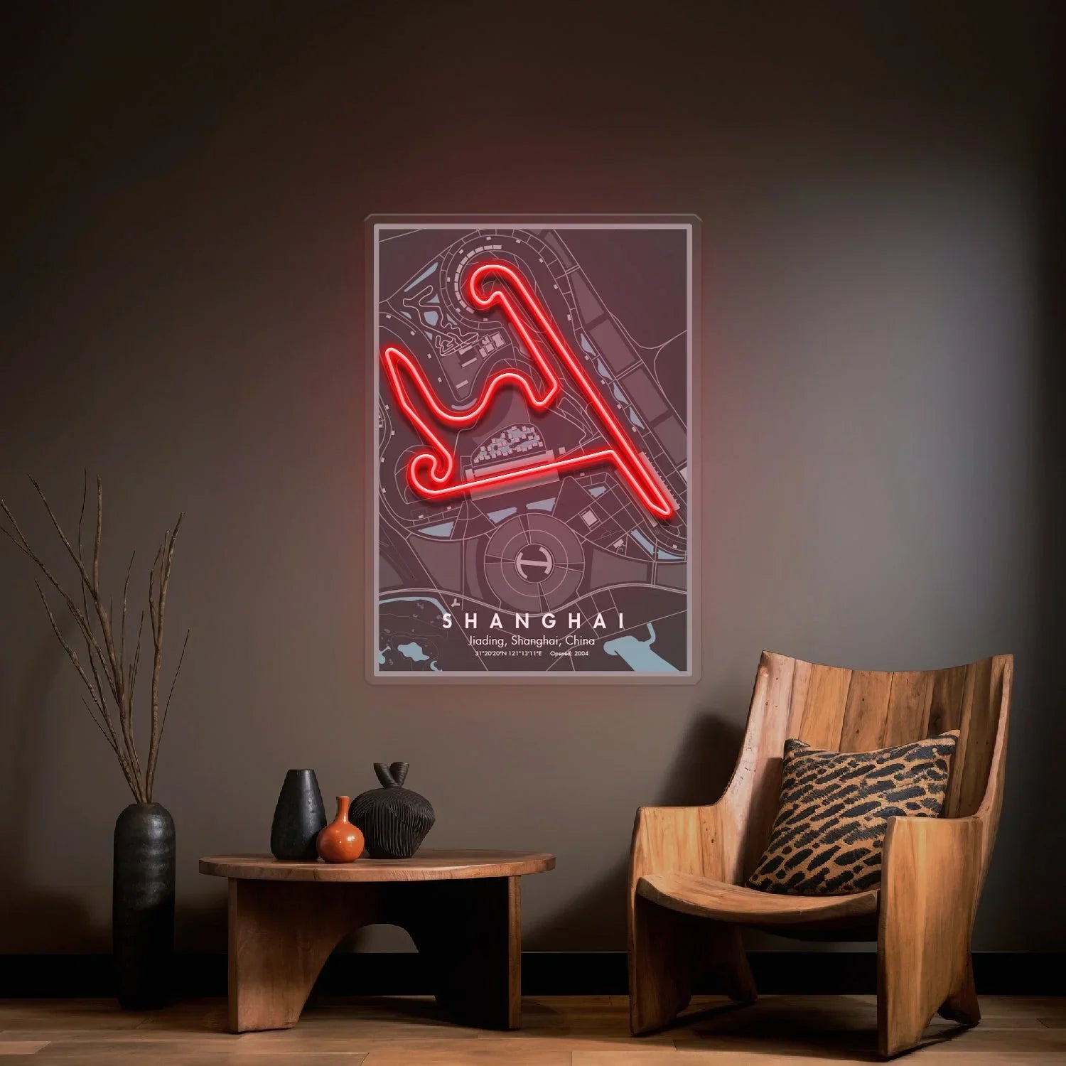 Modern living room with wooden chair, table, vases, and neon-lit Shanghai F1 circuit map wall art