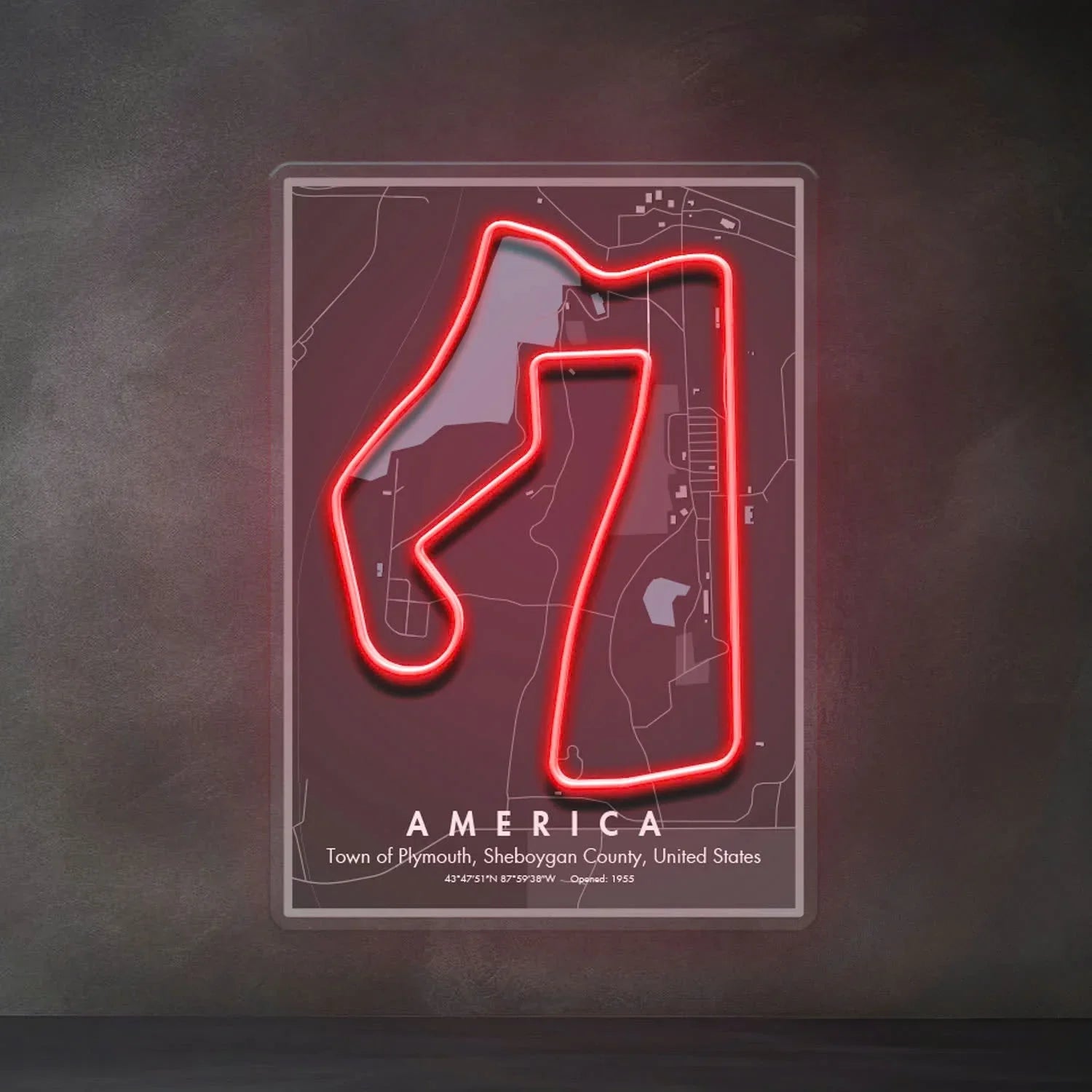 Neon red outline of America race circuit map on wall with location and opening details